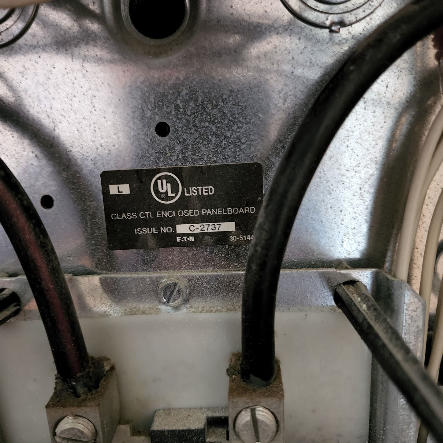Close-up of appliance wiring and metal housing with a UL certification label.