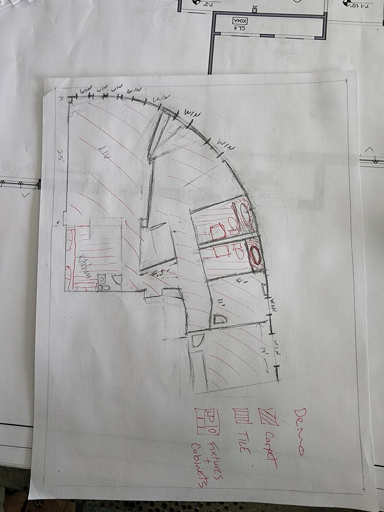 Faded hand-drawn floor plan on white paper with black and red markings.