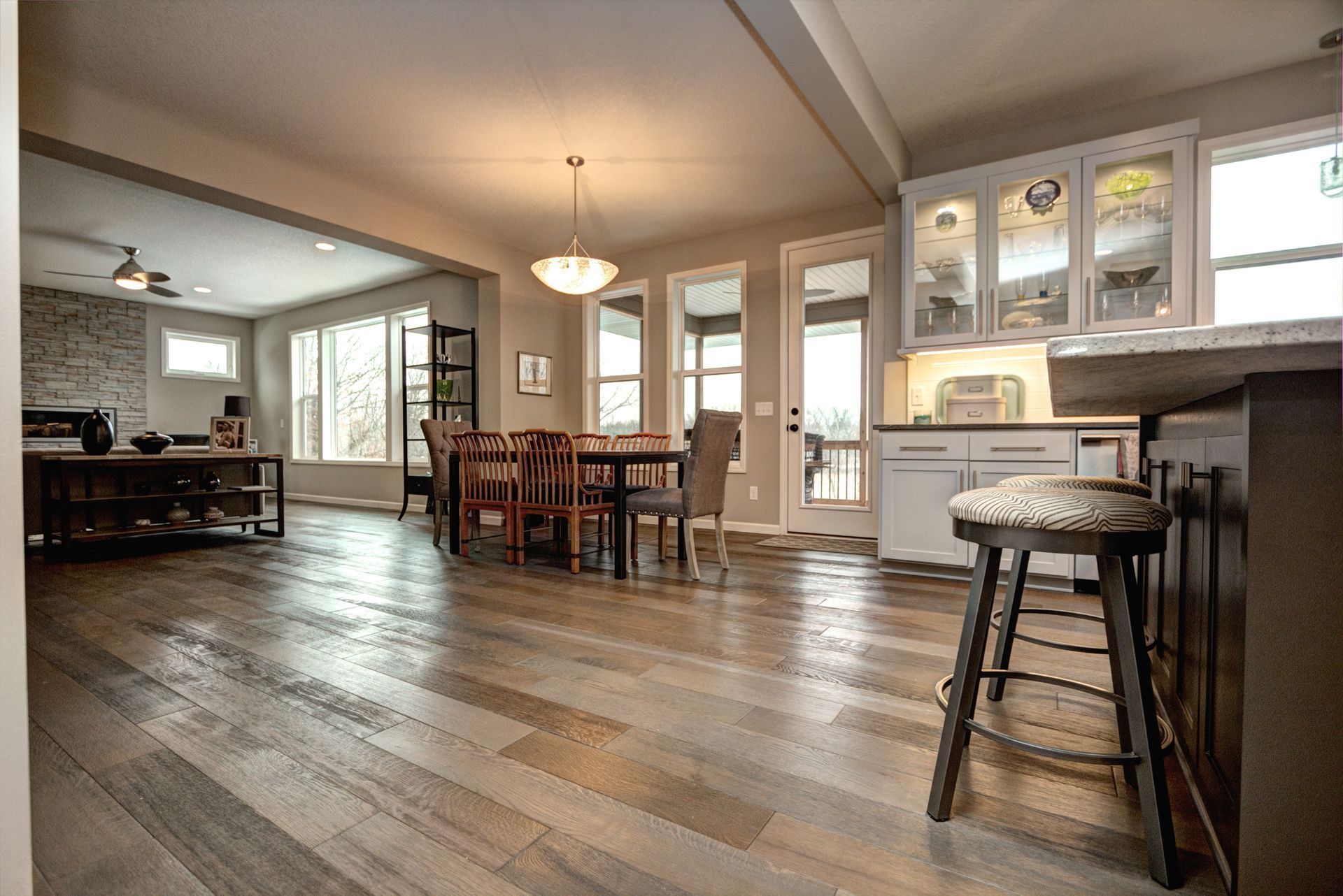 Kitchen with hardwood floors, dining table, and bar seating.