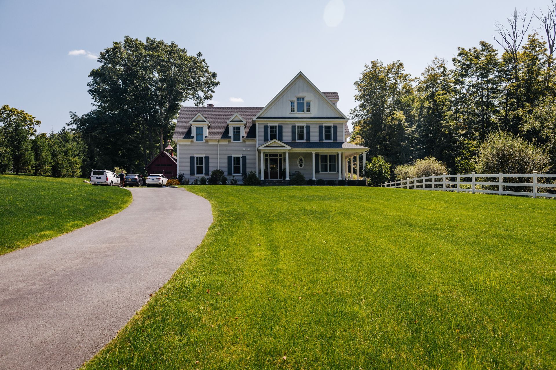 A large white house with a driveway leading to it