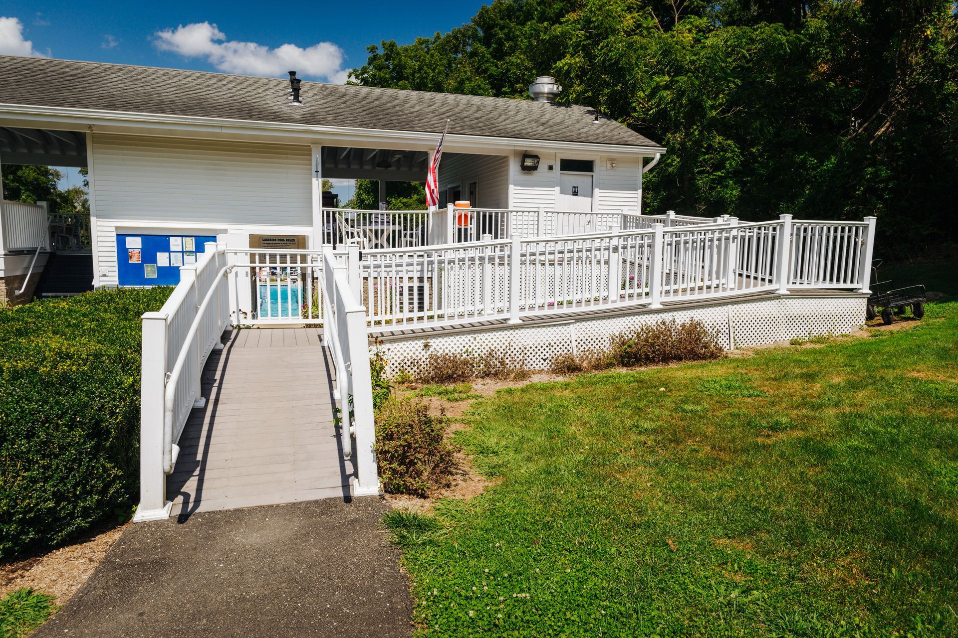 A white house with a ramp leading to it.