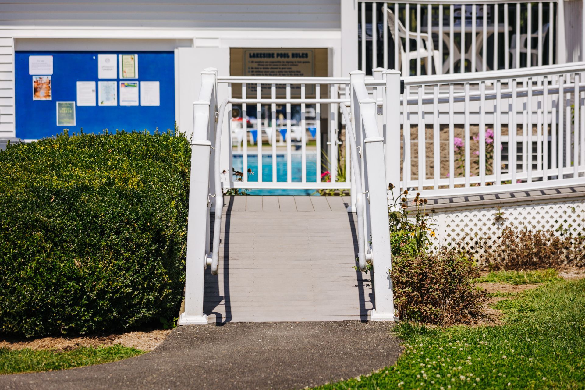 A white fence with a ramp leading to a building