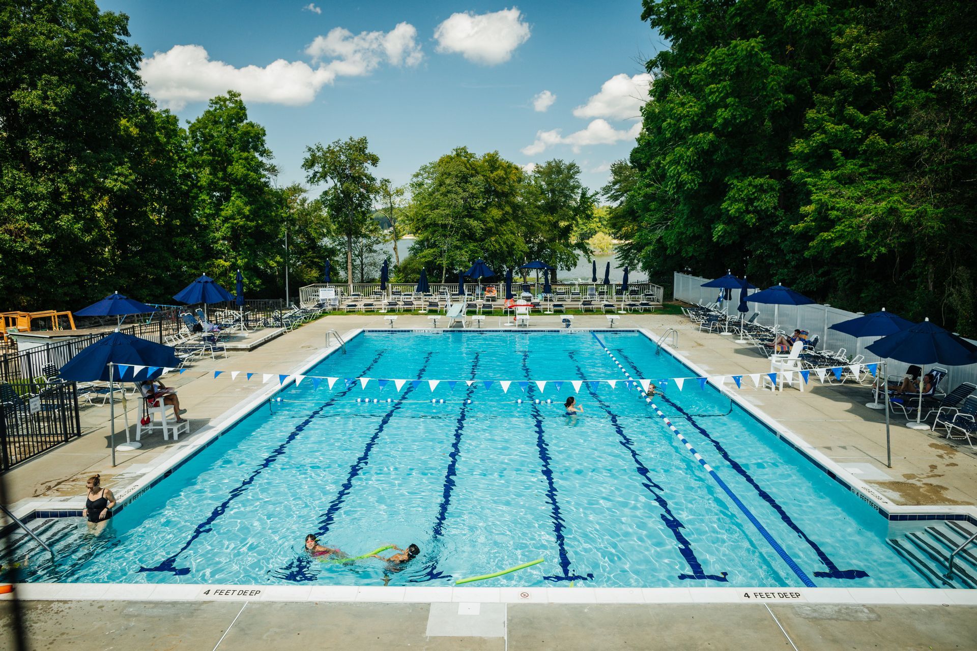 A large swimming pool with people swimming in it