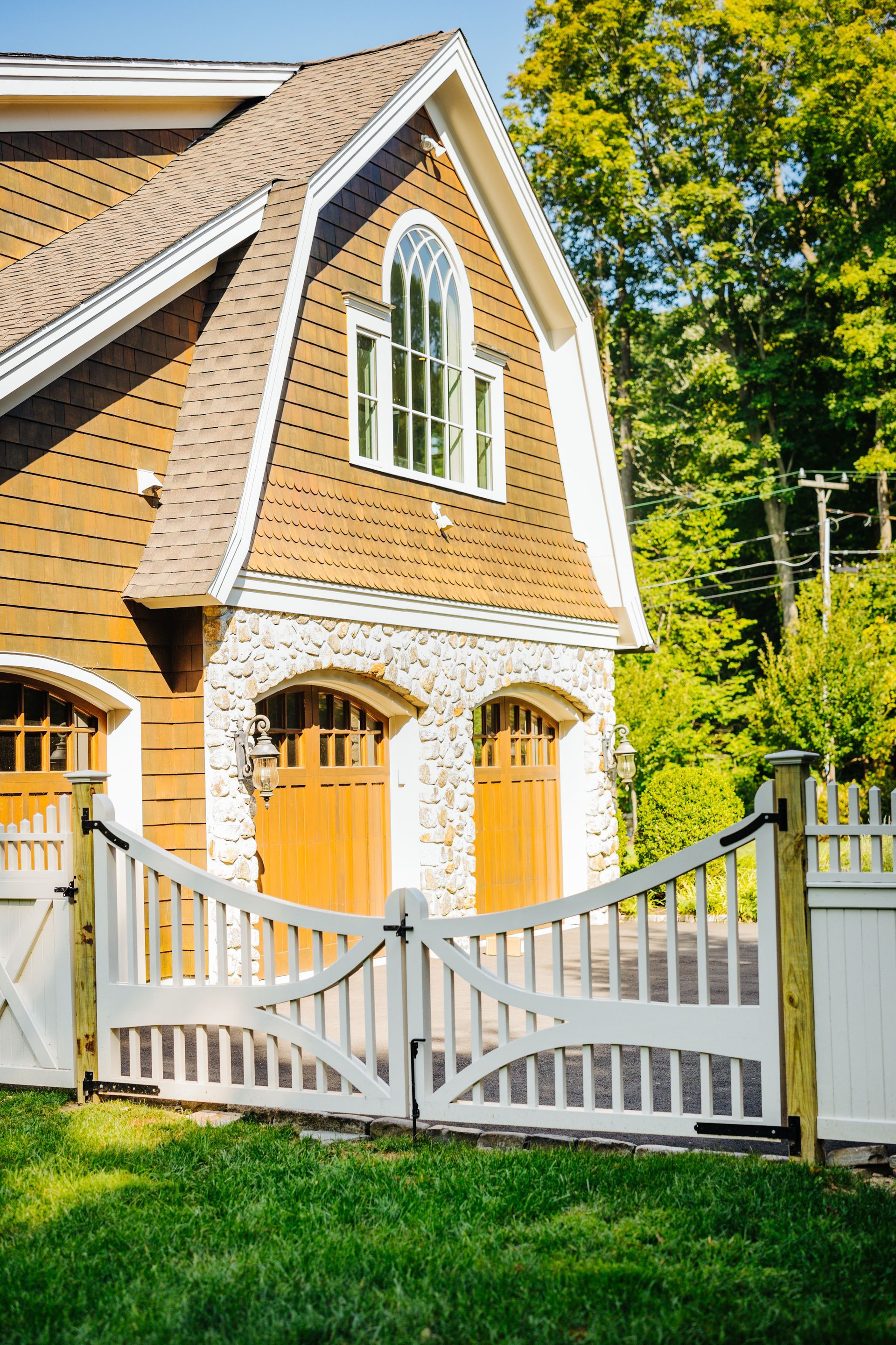 A large house with a white gate in front of it.