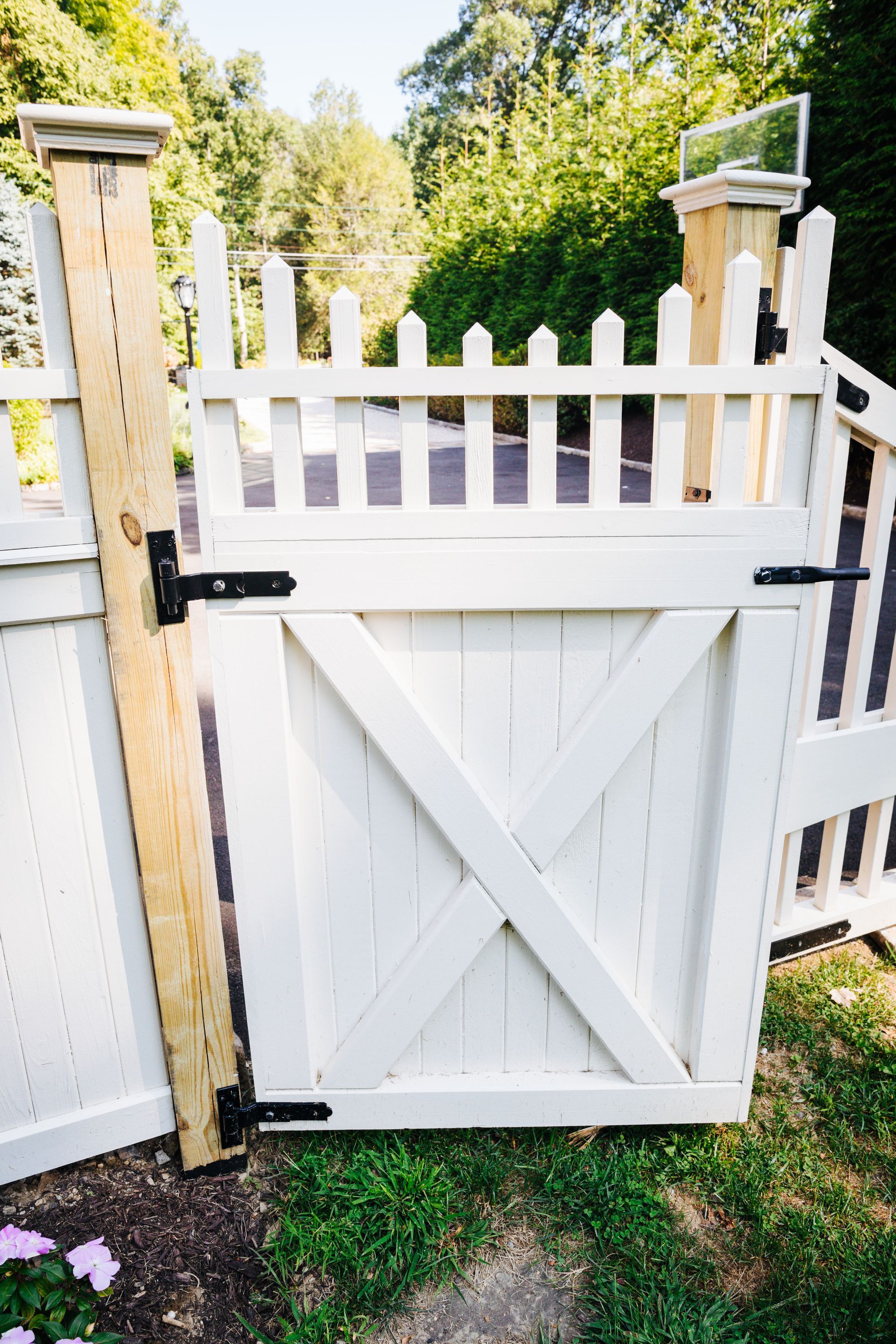 A white picket fence with a gate in the middle of it.