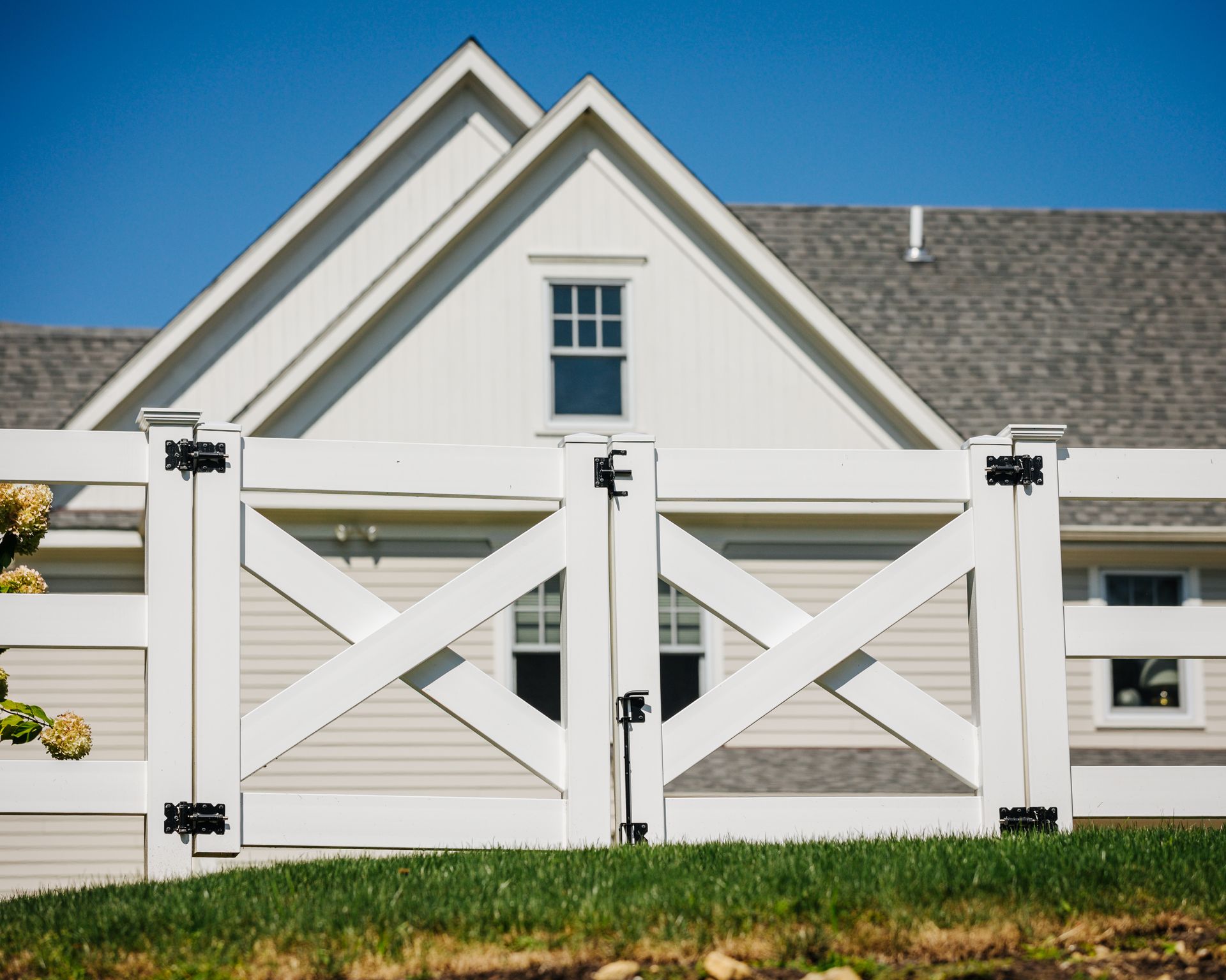 A white house with a white fence in front of it