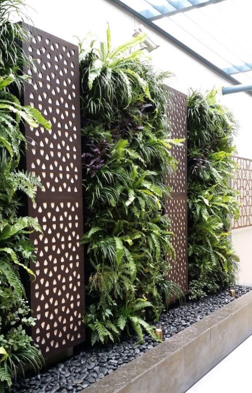 A fence with a lot of plants growing on it.