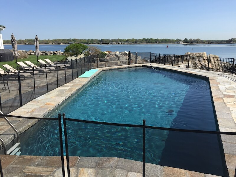 A large swimming pool with a fence around it