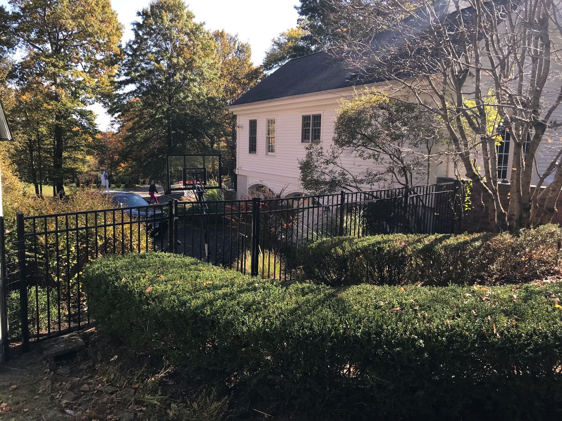 A white house with a black fence in front of it