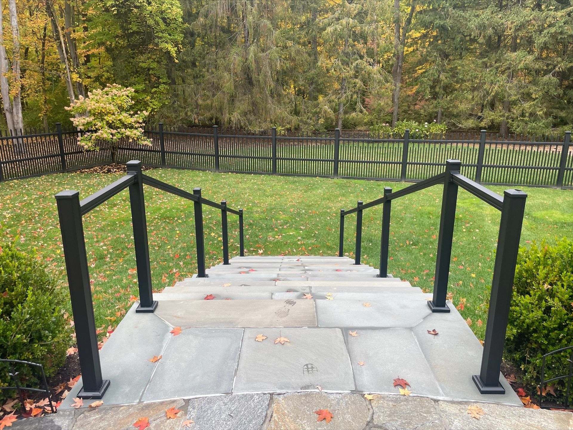 A set of stairs leading up to a lush green field.
