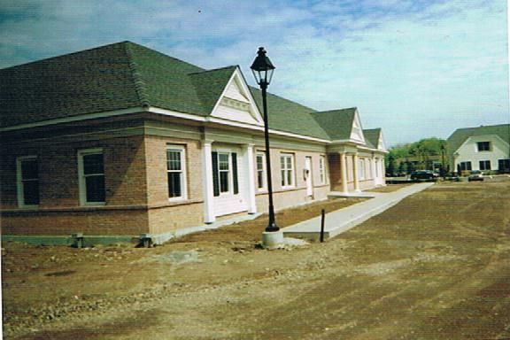 A row of brick buildings with a street light in front of them