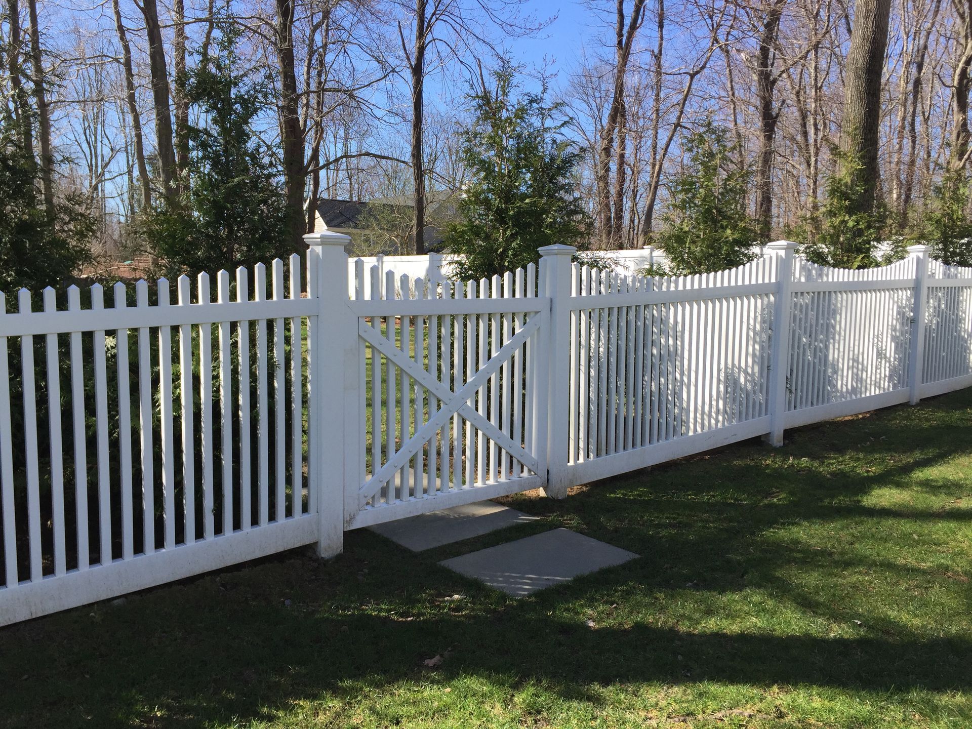 A white picket fence with a cross on it