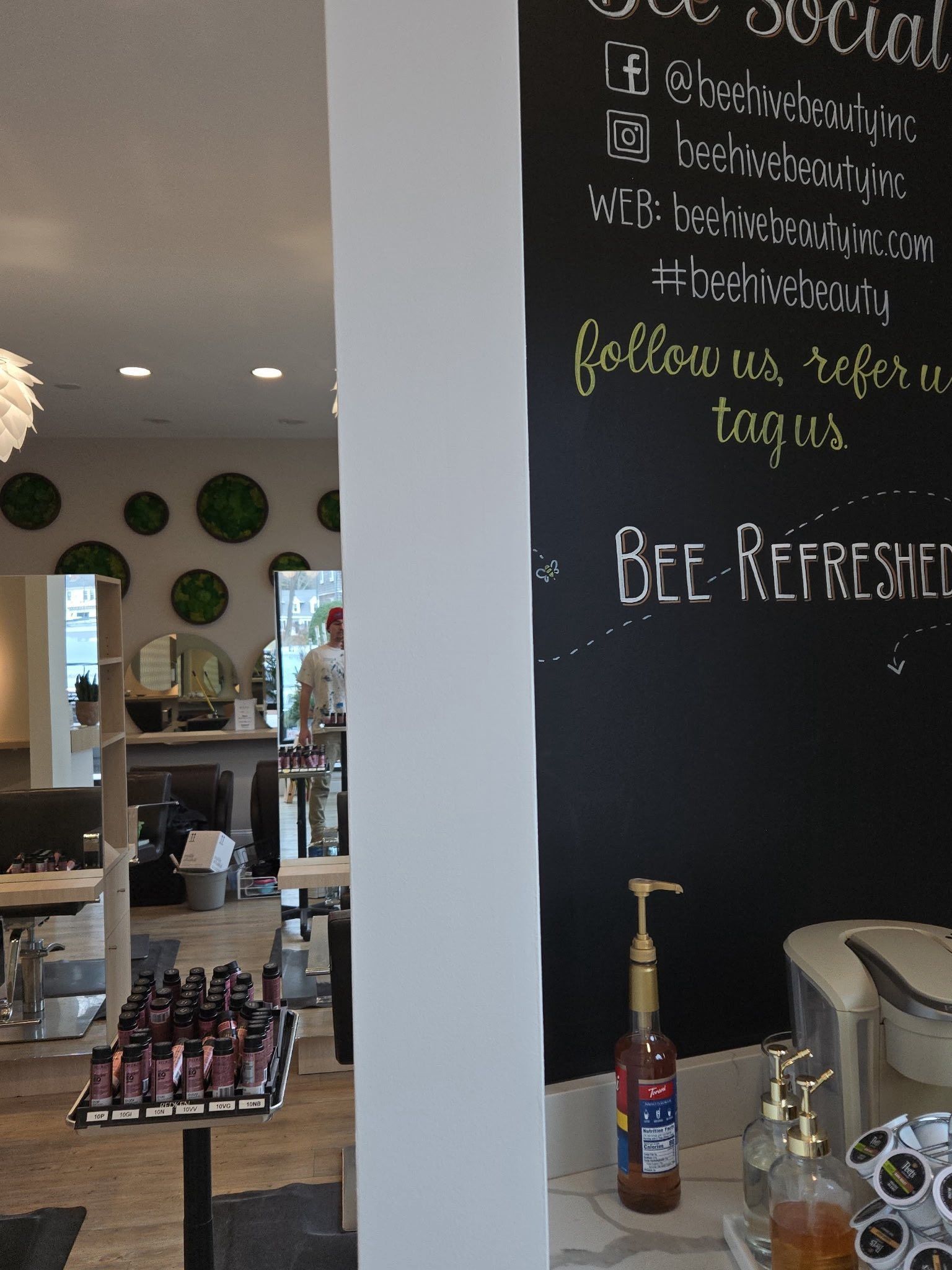 Cafe interior with chalkboard menu, beer taps, and bottled drinks on a counter