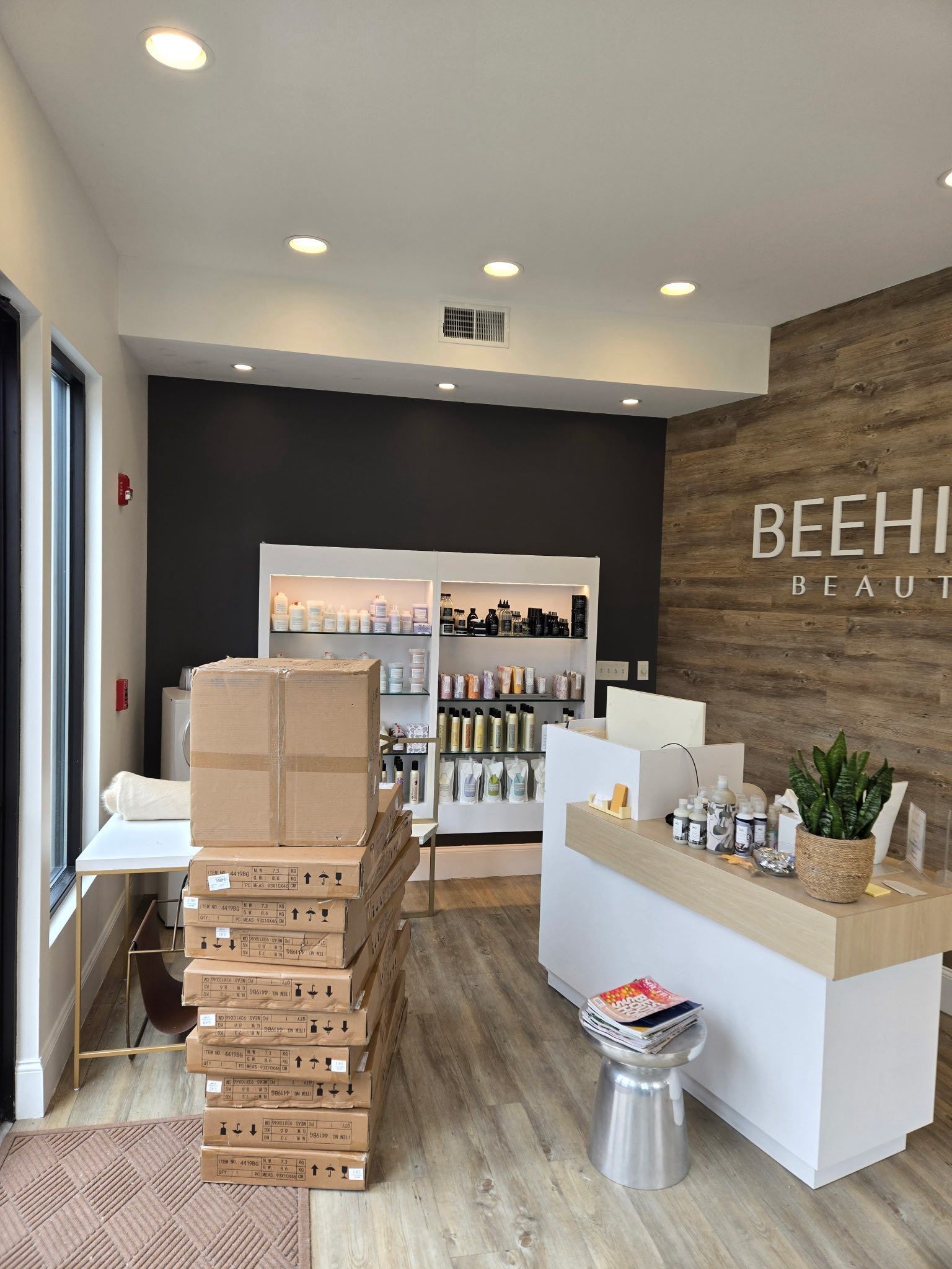 Store interior with stacked boxes, white counter, and product shelves in a modern retail space