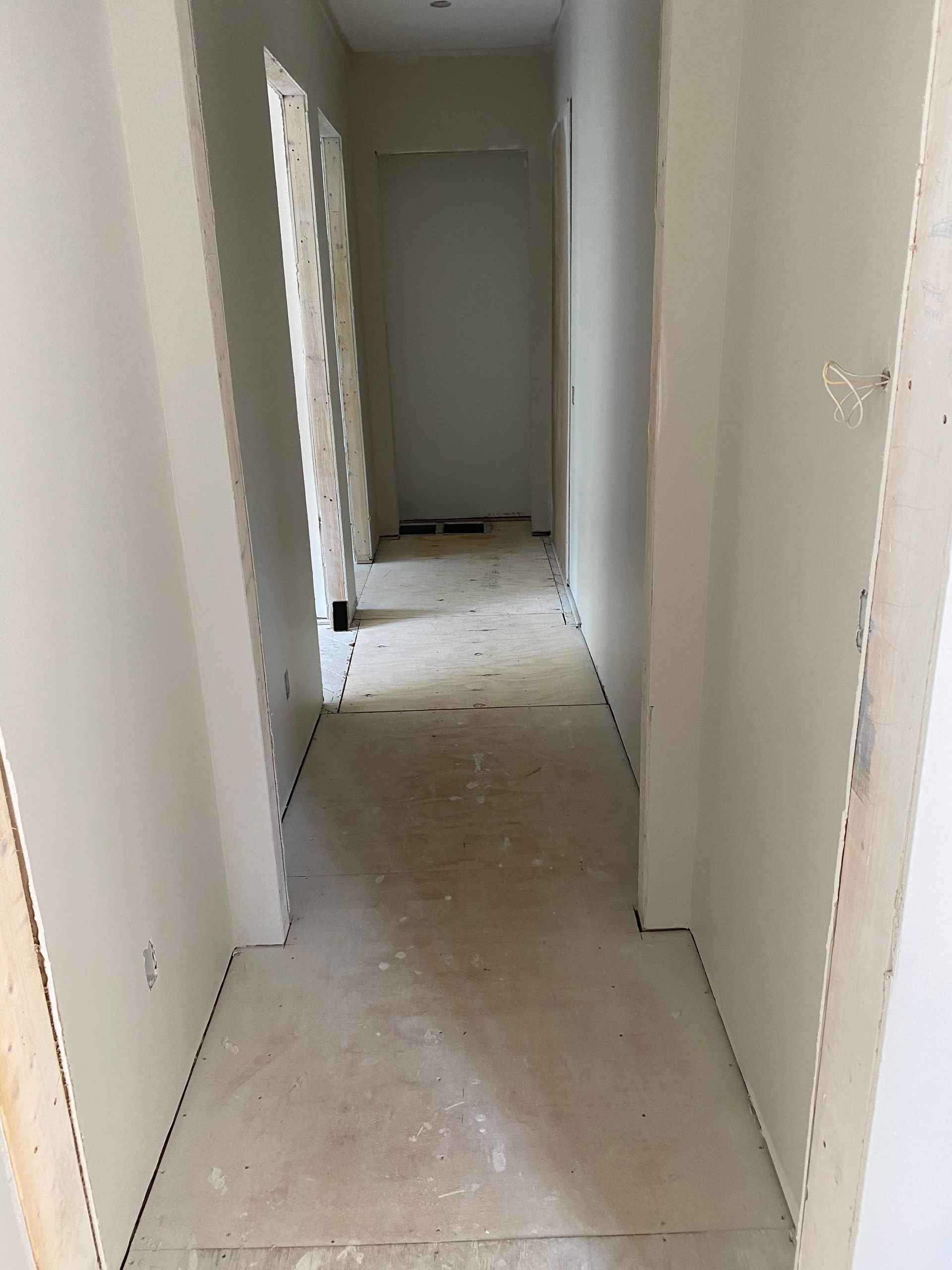 A long hallway in a house under construction.