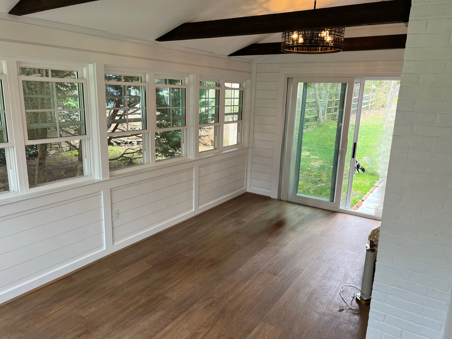 A room with a lot of windows and a sliding glass door.