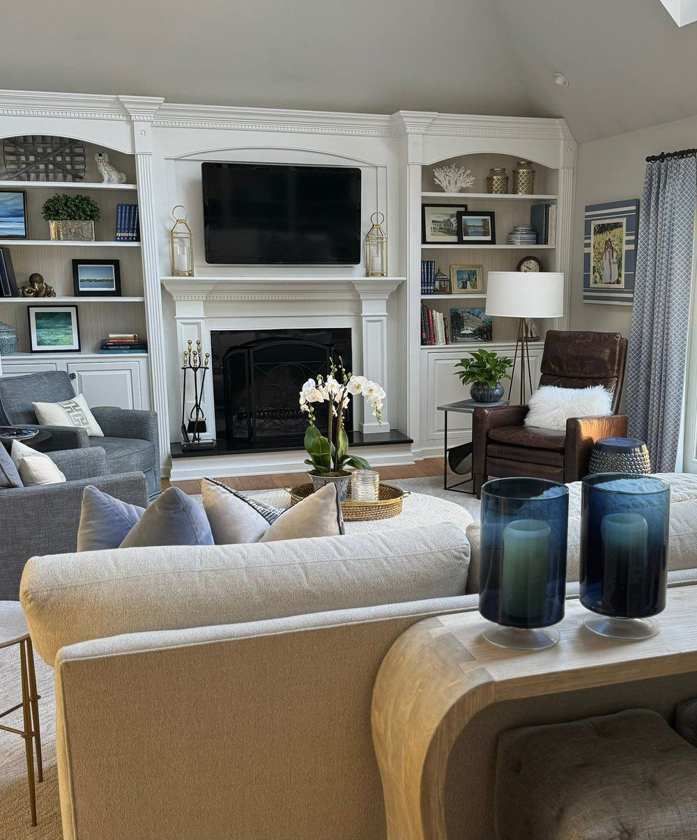 A living room with a fireplace and a flat screen tv