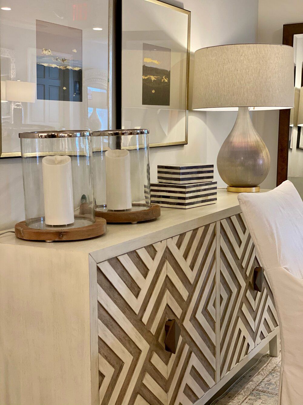 A living room with a dresser with a geometric pattern on it