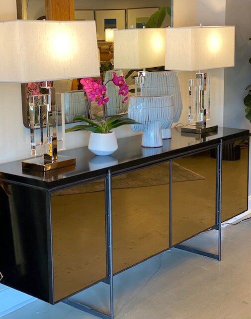 A table with a vase of pink flowers on it