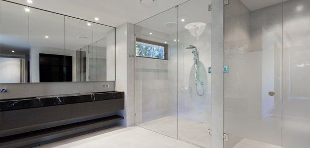 Bathroom with mirrors and glass enclosure