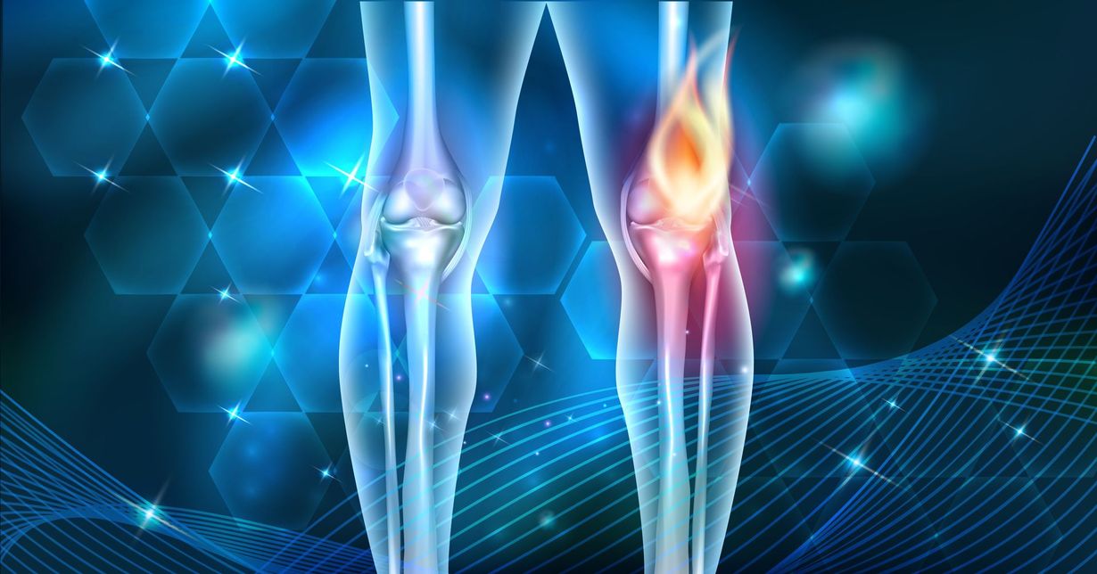A person's ankle being treated by a laser therapy device on a black examination table.