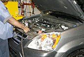 Engineer checks the automobile mechanism in garage
