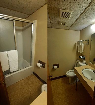 Bath tub with shower, toilet, sink, and vanity mirror