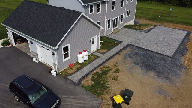 An aerial view of a house with a car parked in front of it.