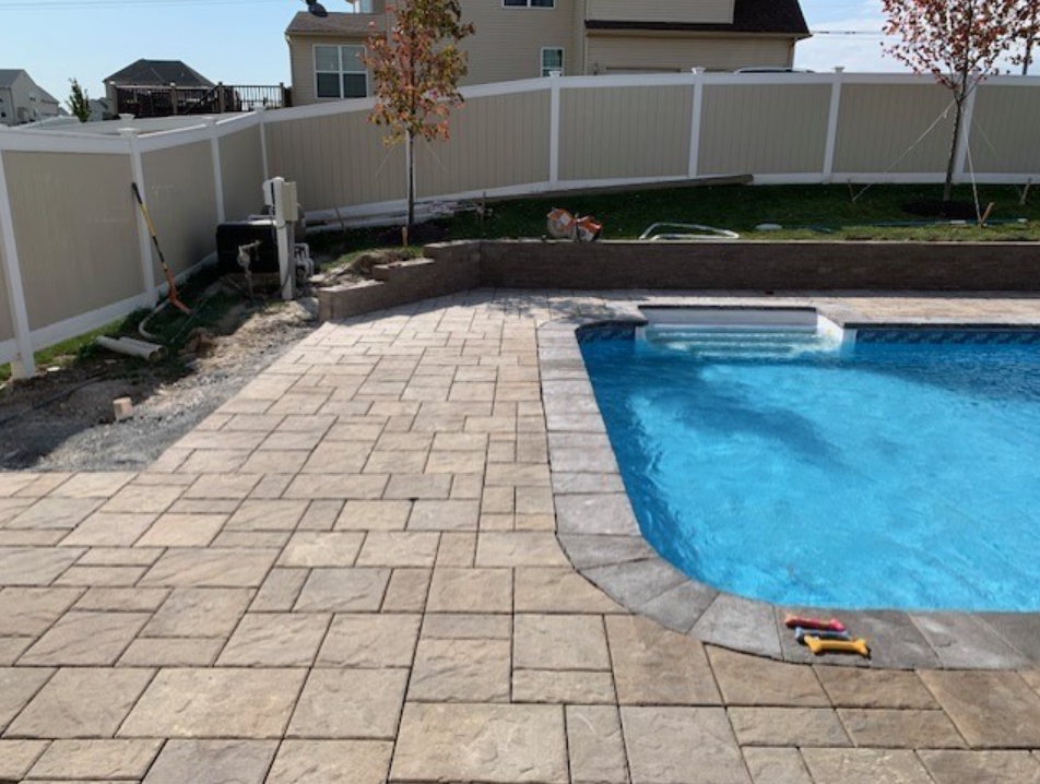A swimming pool with a white fence surrounding it