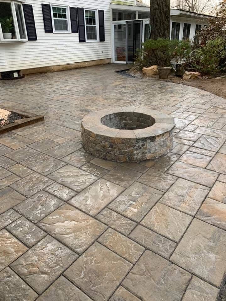 There is a fire pit in the middle of the patio.