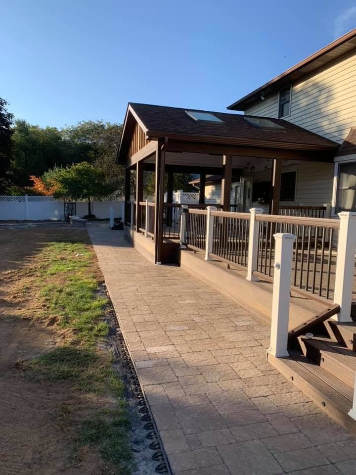A house with a covered porch and a walkway leading to it