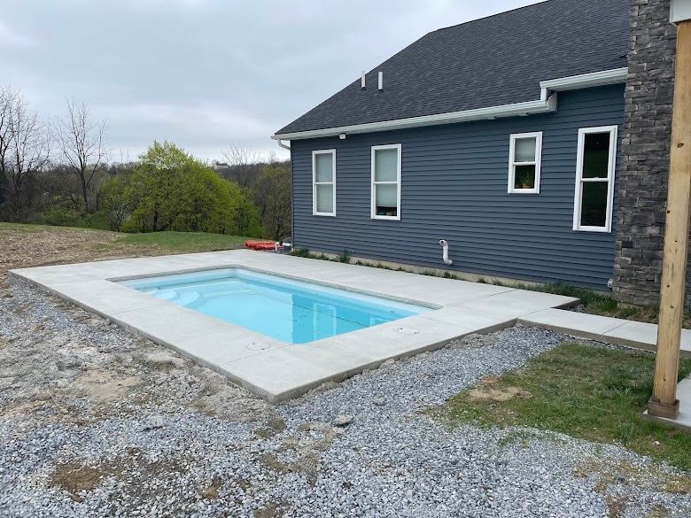 A house with a swimming pool in front of it