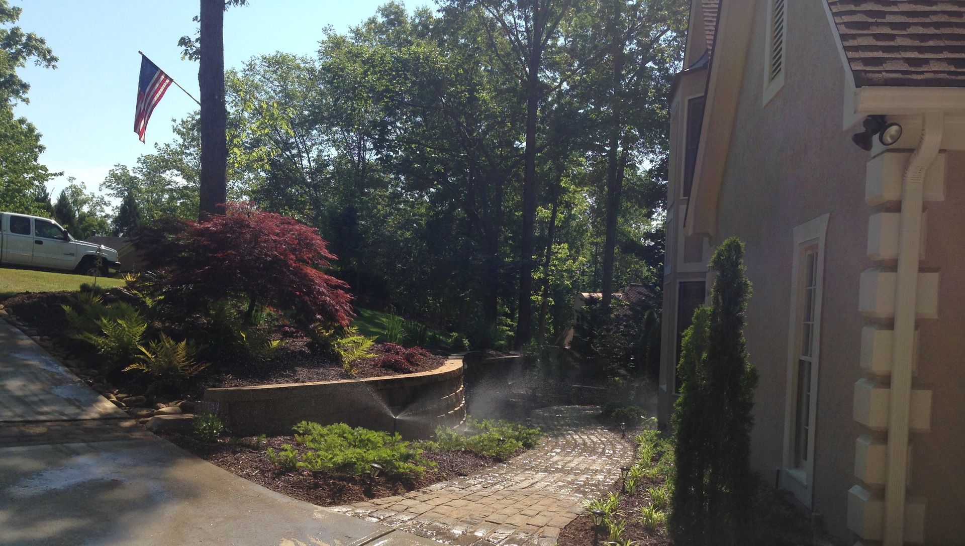A white truck is parked in the driveway of a house