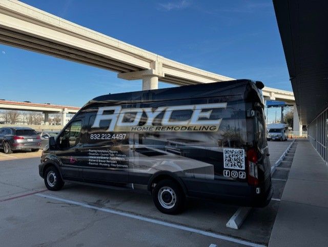 Black Royce Home Remodeling van parked under an overpass.