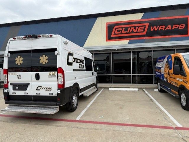 White ambulance with star of life emblems parked outside 