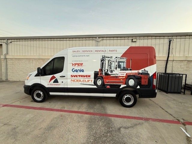 White van with forklift graphic, red accents, parked in front of a building.