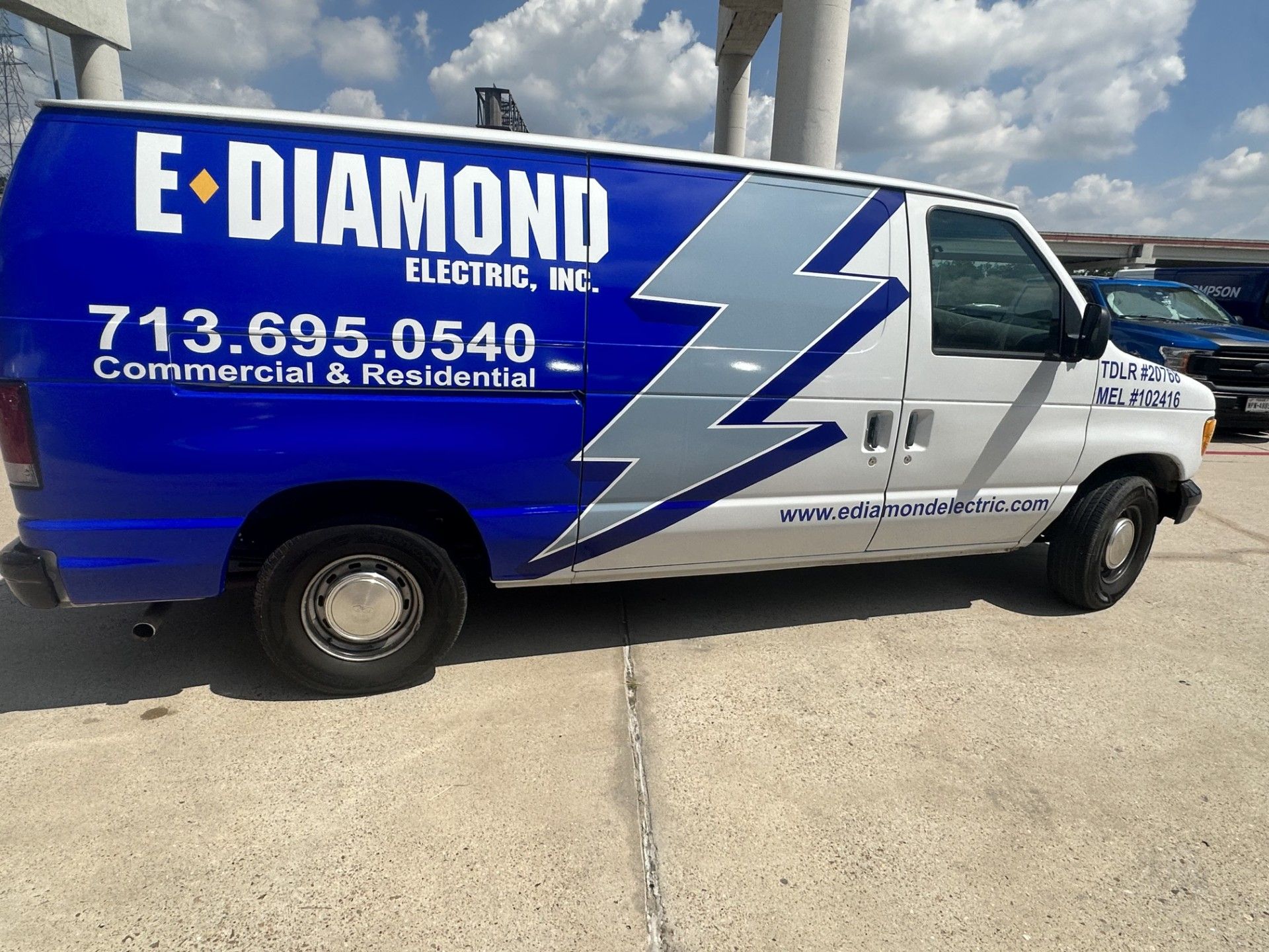 Blue and white E-Diamond Electric van with company logo and phone number.