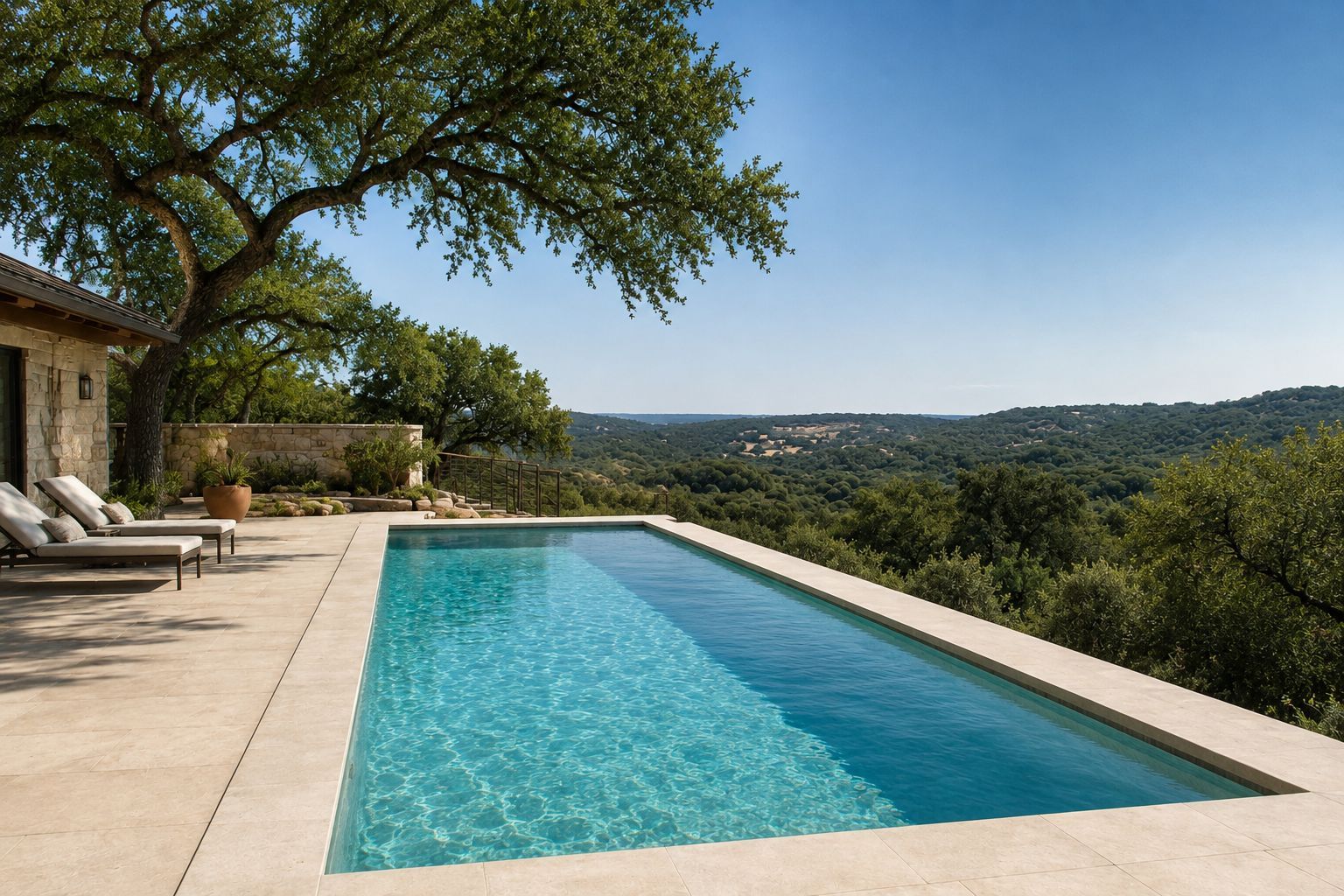 Infinity pool overlooking a green hillside under a clear blue sky