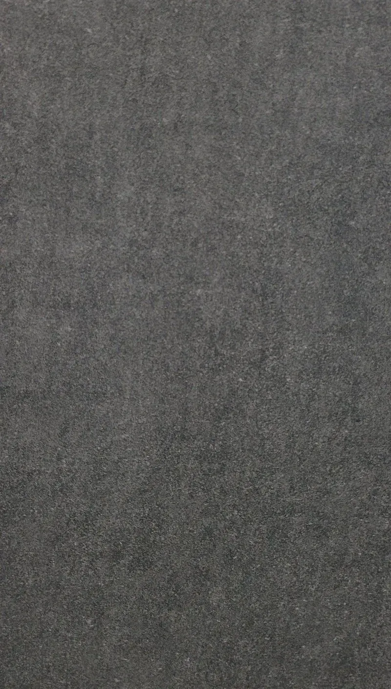 Dark gray textured fabric or carpet background.