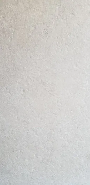Light beige textured wall with a thin vertical seam on the right edge