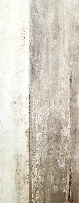 Close-up of a weathered beige and white wall with peeling paint and stains