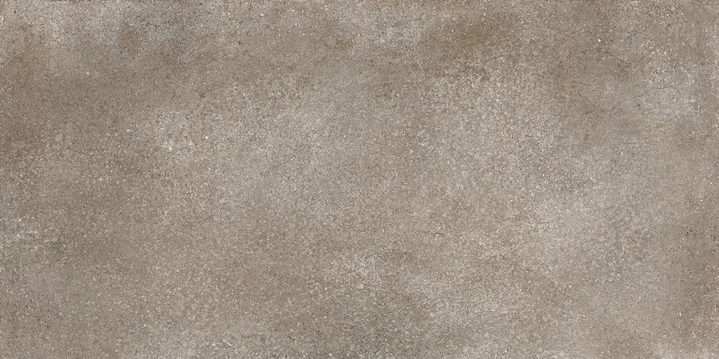 Close-up of a beige, textured stone or concrete surface with a mottled pattern