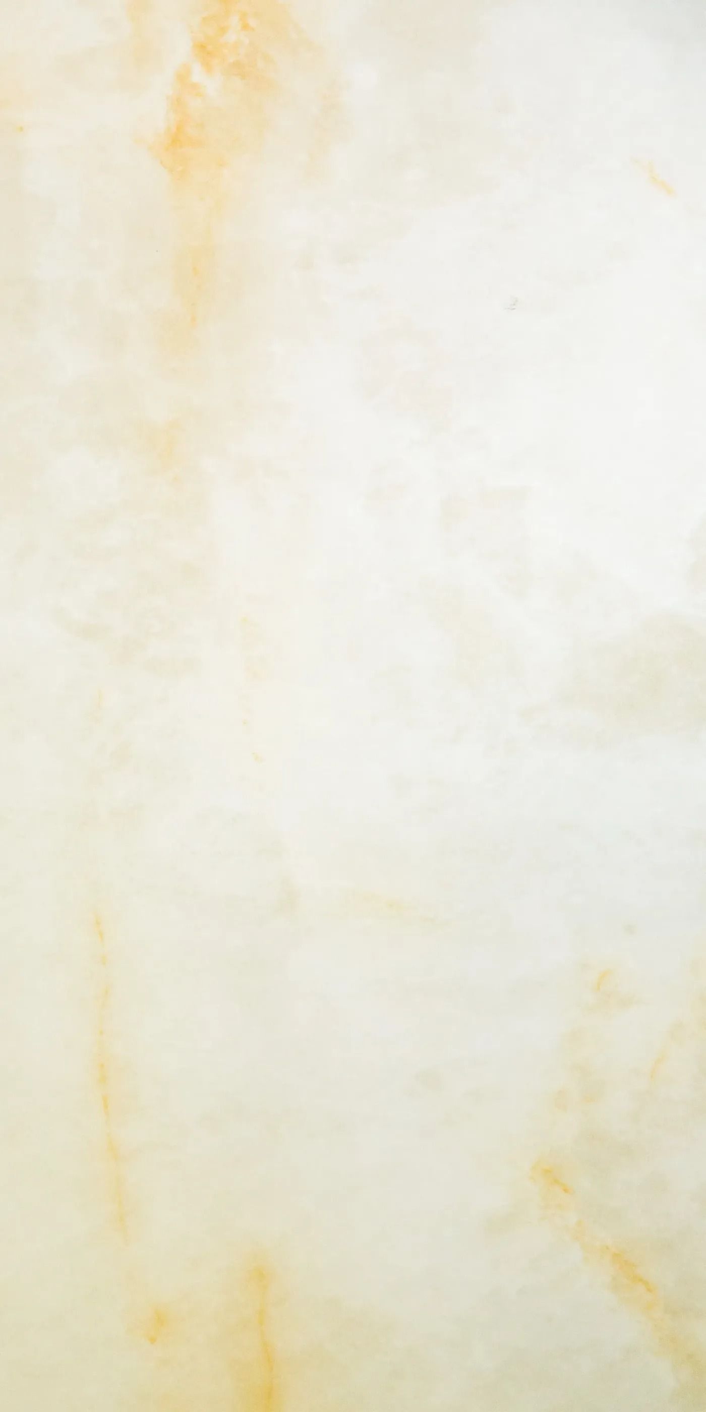 Light beige marble-like texture with faint yellow veining and soft cloudy patterns