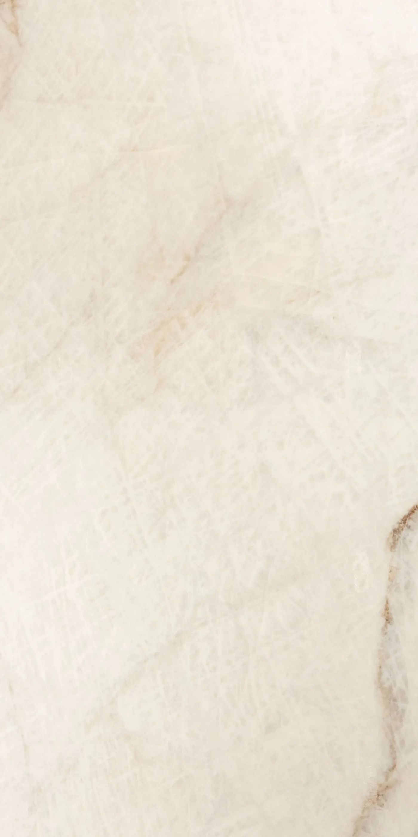 Close-up of a light beige textured surface with faint gray veining