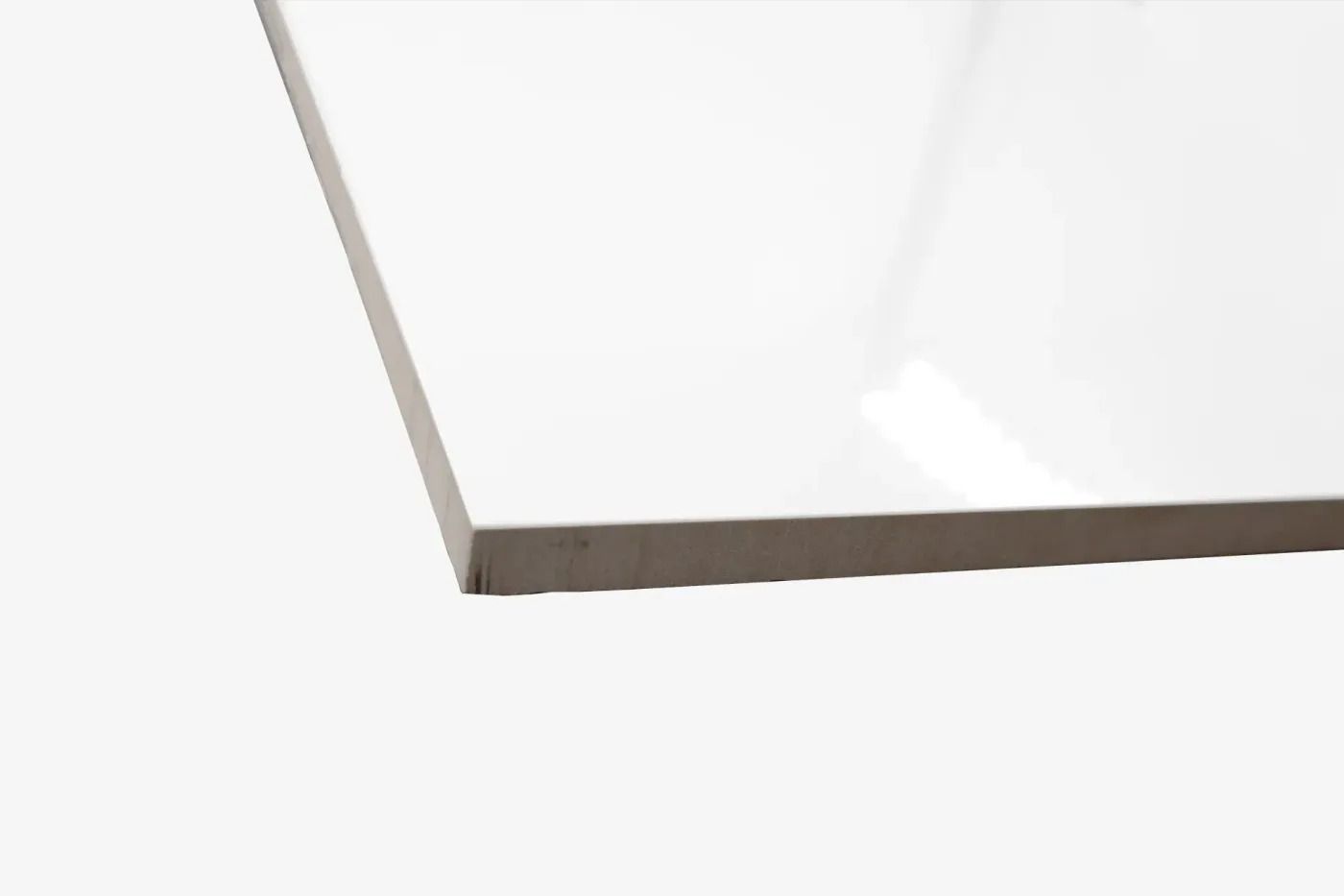 White tabletop corner with a light gray edge on a white background