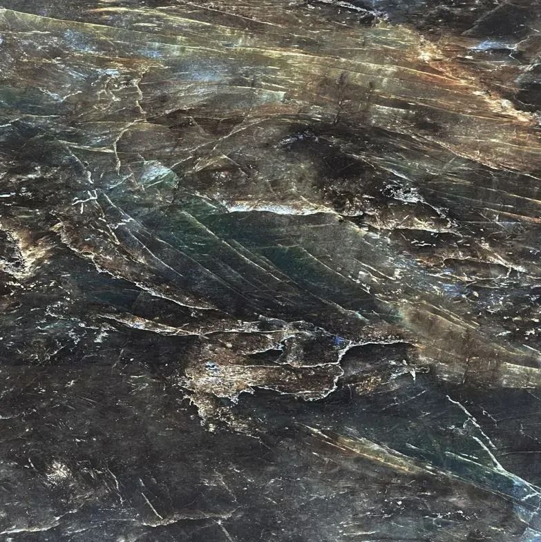 Dark marbled rock surface with brown, gray, and blue streaks and veins