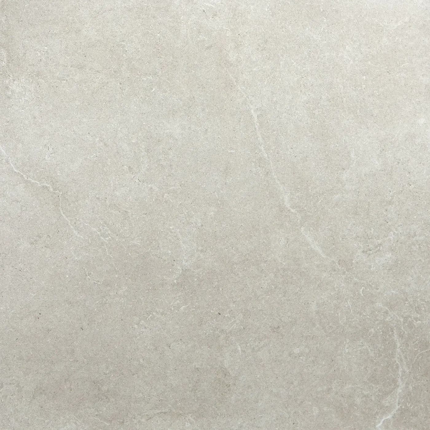 Close-up of light beige stone or marble surface with faint white veining