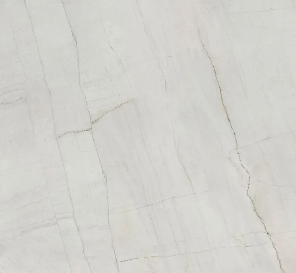 Close-up of a light gray marble or stone surface with faint veining and fine cracks