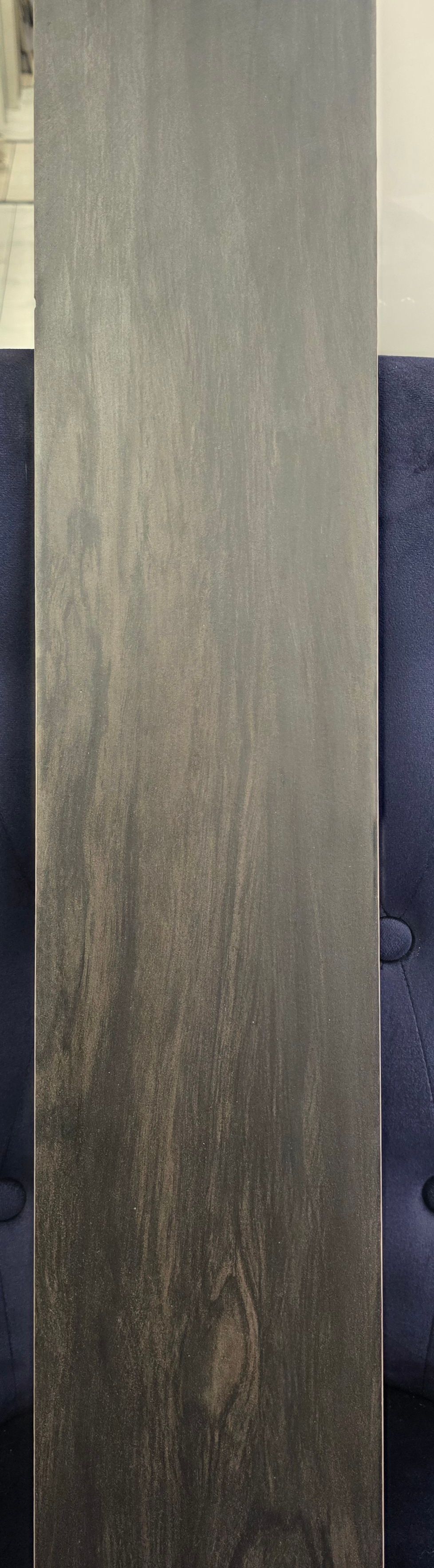 Vertical gray textured panel with a dark blue surface partially visible on the right.