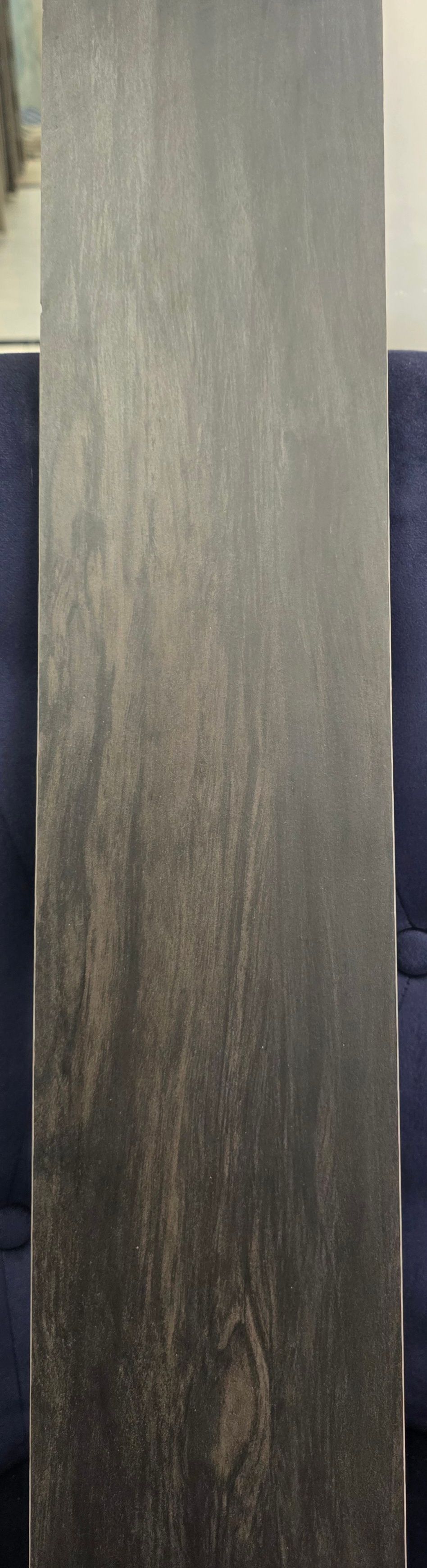 Close-up of a vertical gray-brown textured panel with dark edges